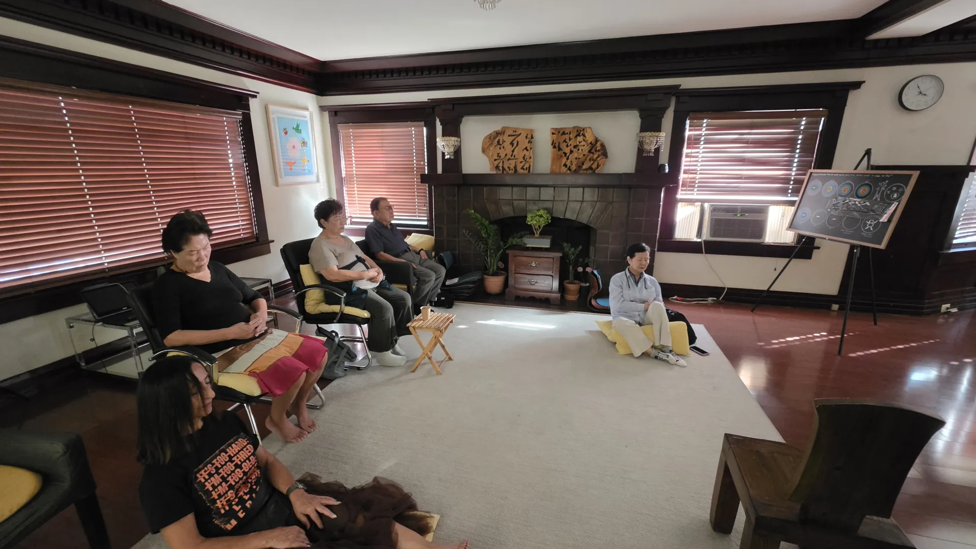 Older adults meditating together in chairs and on cushions at Metime Mindful
