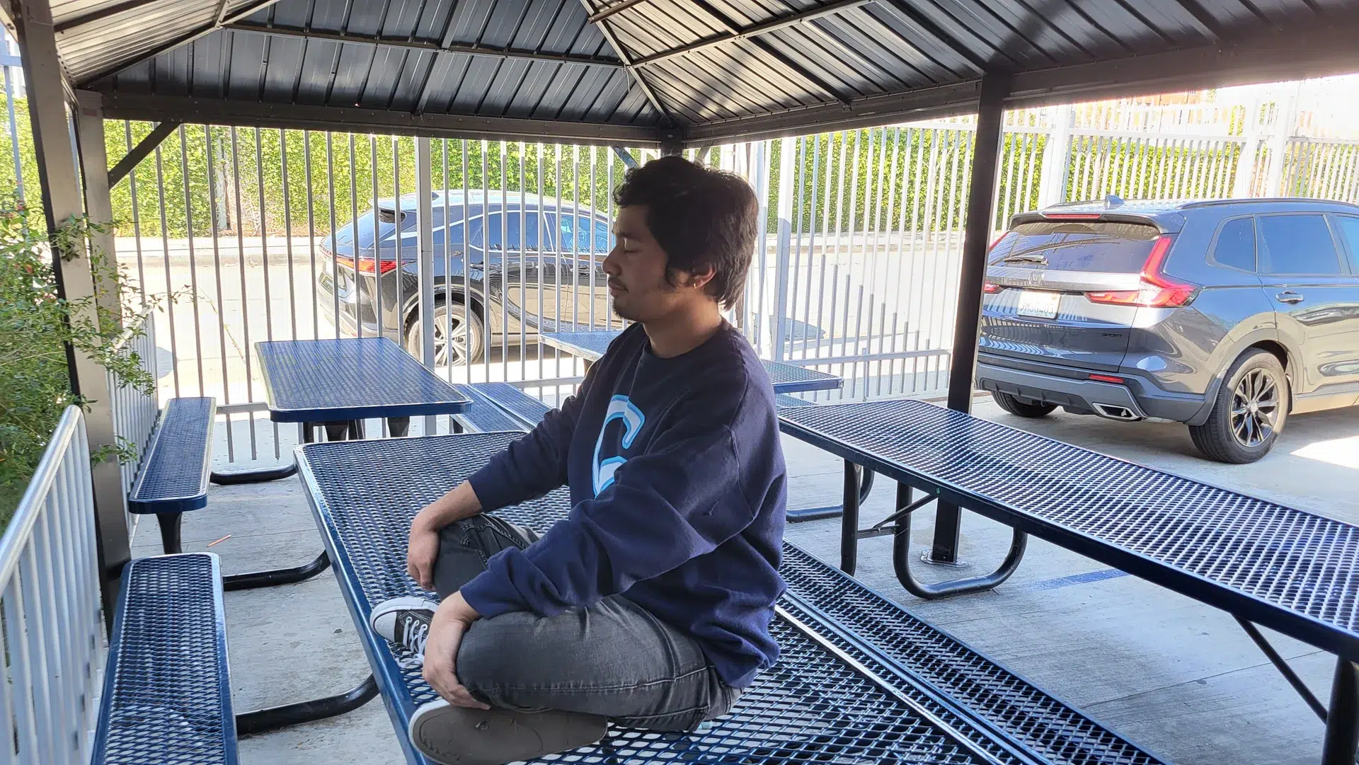 A high school student meditating outdoors during a Metime Mindful session
